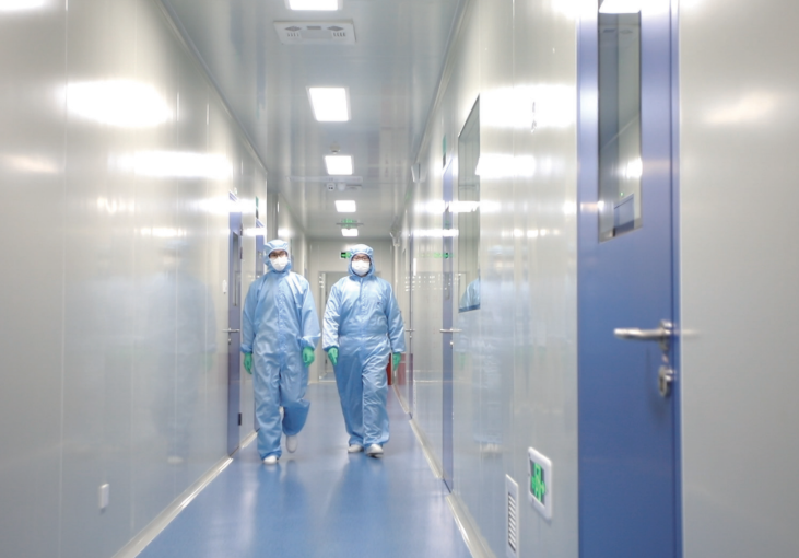 Technicians walking through an ISO Class 7 cleanroom corridor